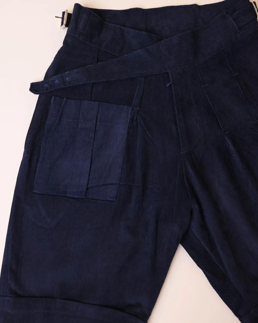 A “Gurkha”pant shorts with pleats, double side strap buckle, combat patch pocket.