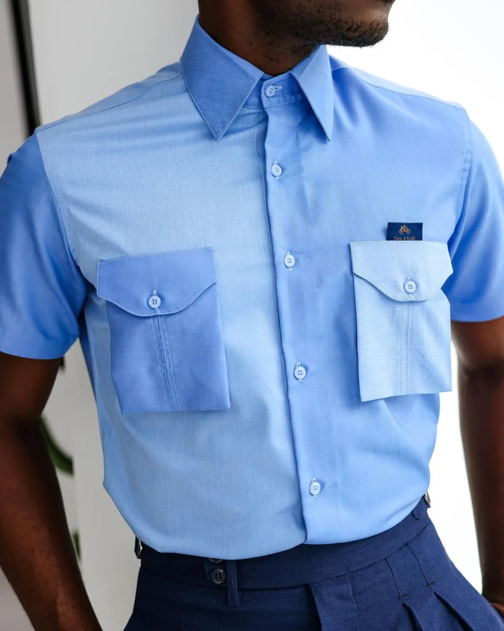 A Herringbone mix shade of blue English spread collar short sleeve casual shirt with double patch pocket.