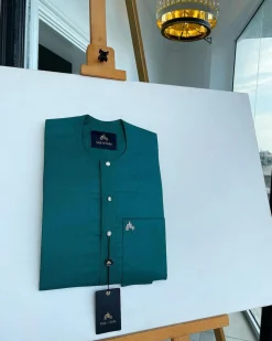 A Hunter green, flap with Swarovski button details, African traditional senator Kaftan native