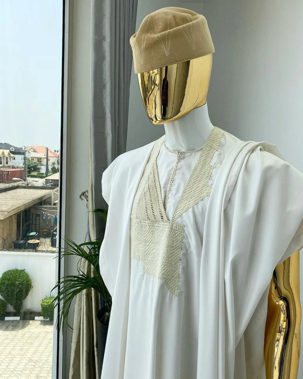 A “jakan” hand woven embroidery agbada, dashiki, sokoto with a cream wool patterned hat.