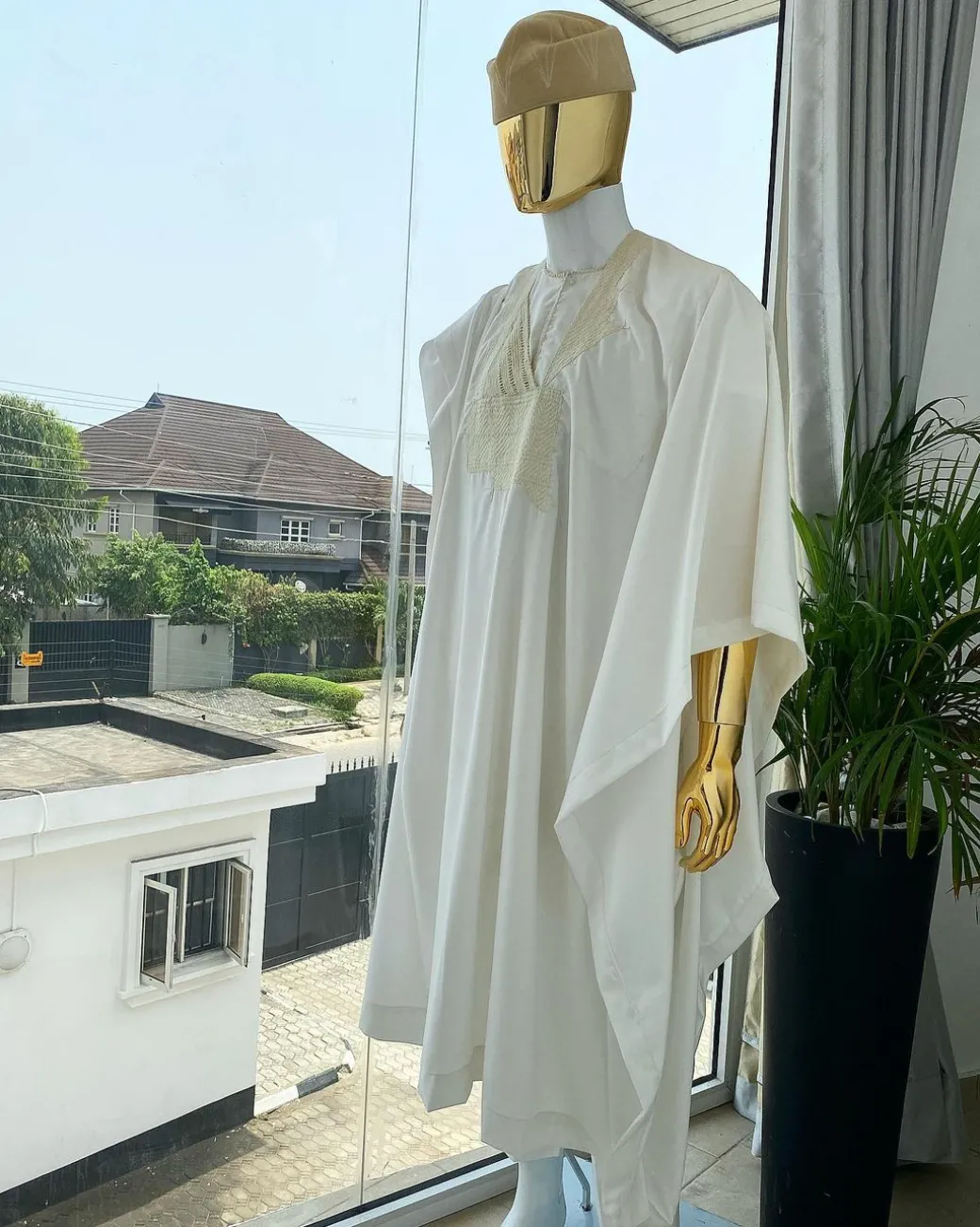 A “jakan” hand woven embroidery agbada, dashiki, sokoto with a cream wool patterned hat.