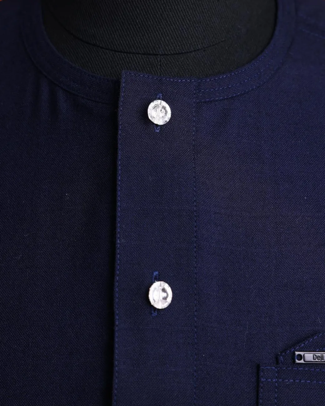 A Jorgecarli wool, midnight blue, invisible windowpane check, front flap with silver Swarovski button, shorts sleeve African senator kaftan native.
