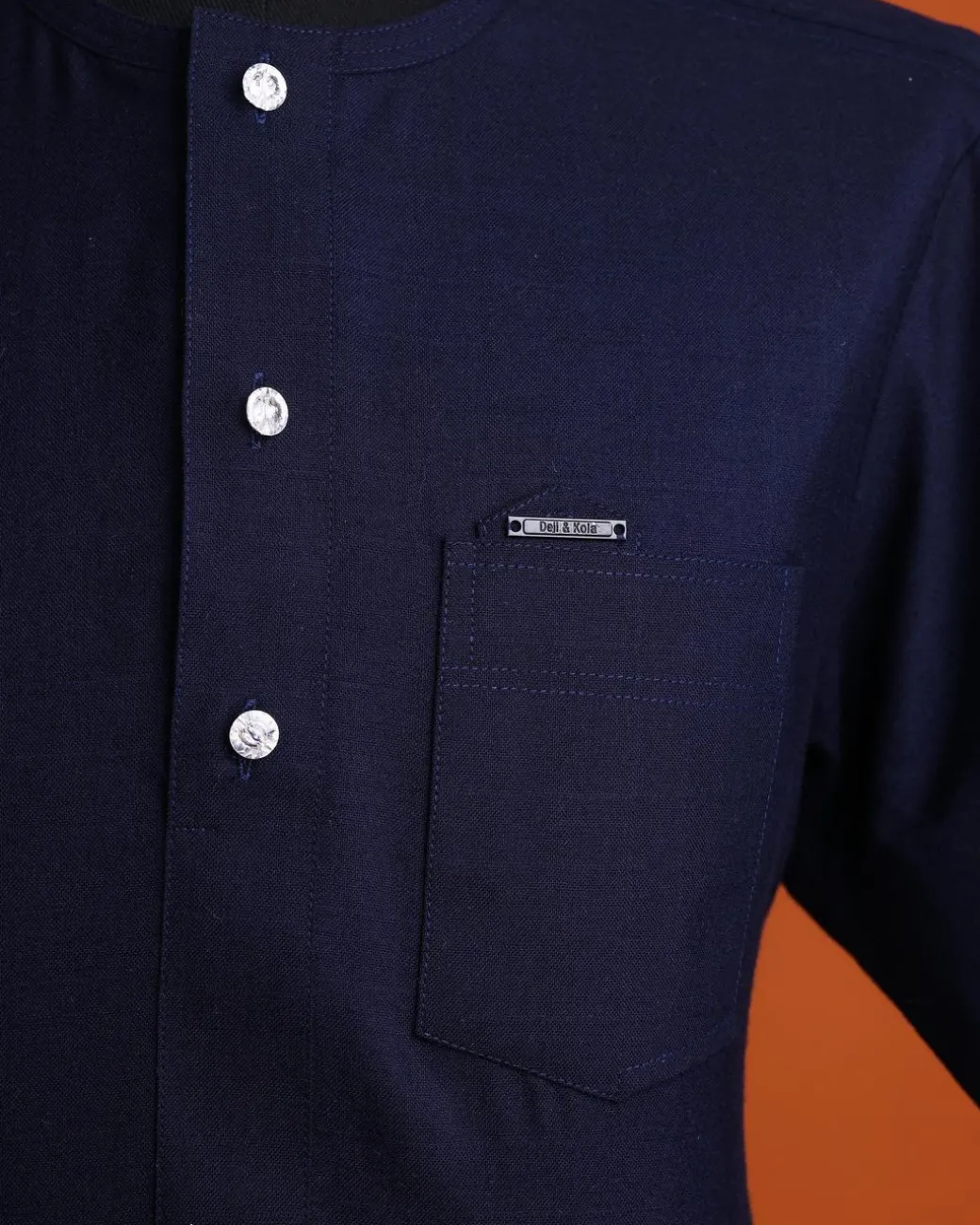A Jorgecarli wool, midnight blue, invisible windowpane check, front flap with silver Swarovski button, shorts sleeve African senator kaftan native.