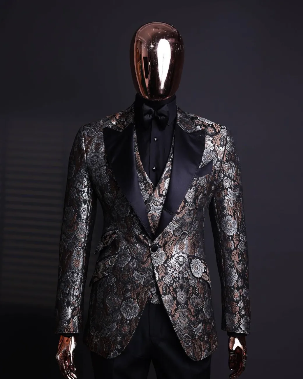 A knitted, brown, silver and black floral jacquard peak lapel suit