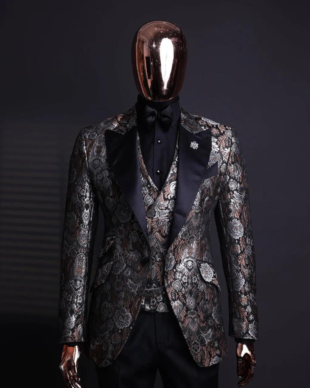 A knitted, brown, silver and black floral jacquard peak lapel suit