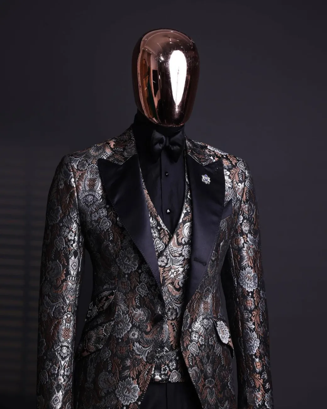 A knitted, brown, silver and black floral jacquard peak lapel suit