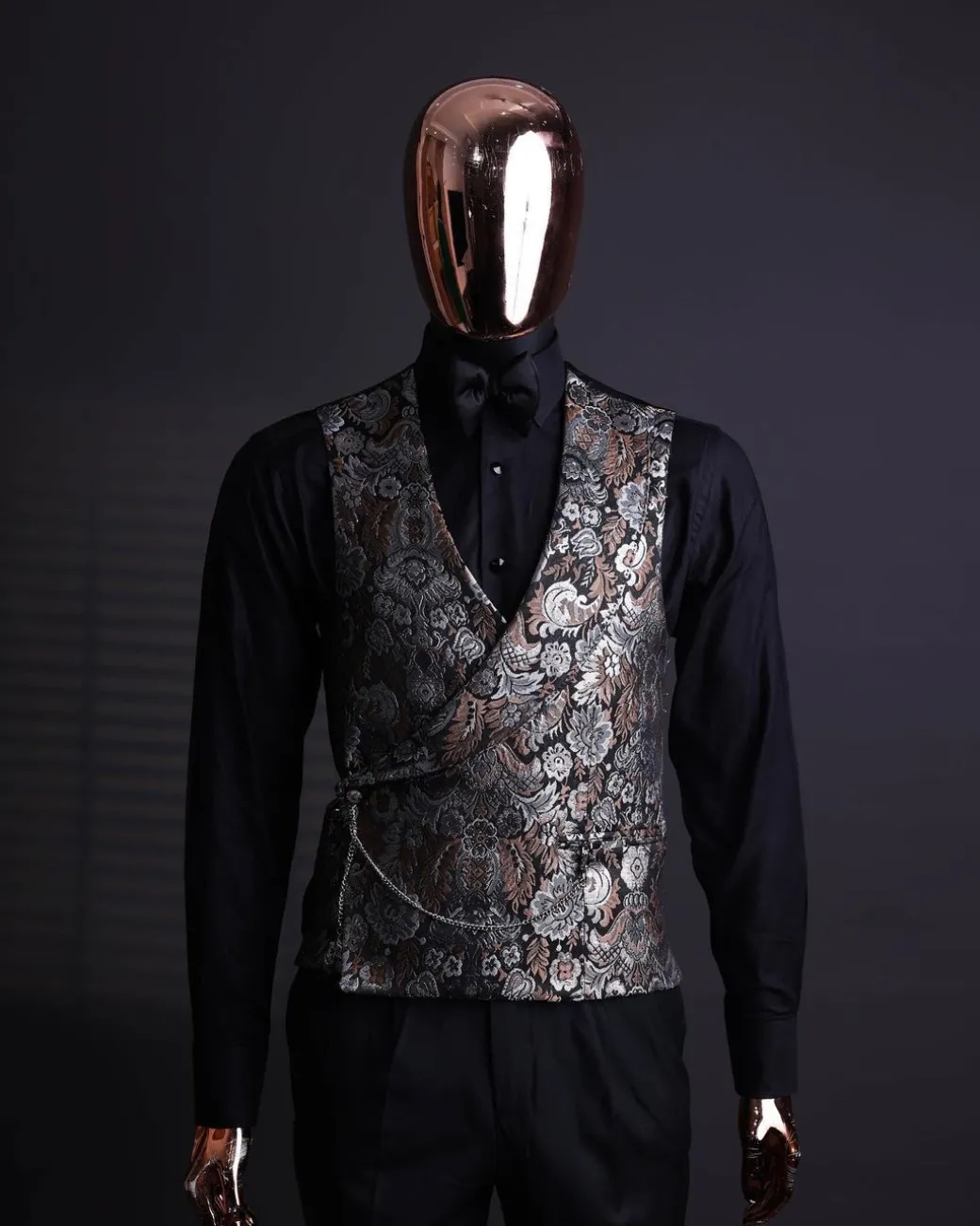 A knitted, brown, silver and black floral jacquard peak lapel suit