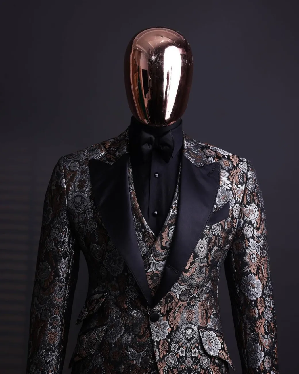 A knitted, brown, silver and black floral jacquard peak lapel suit
