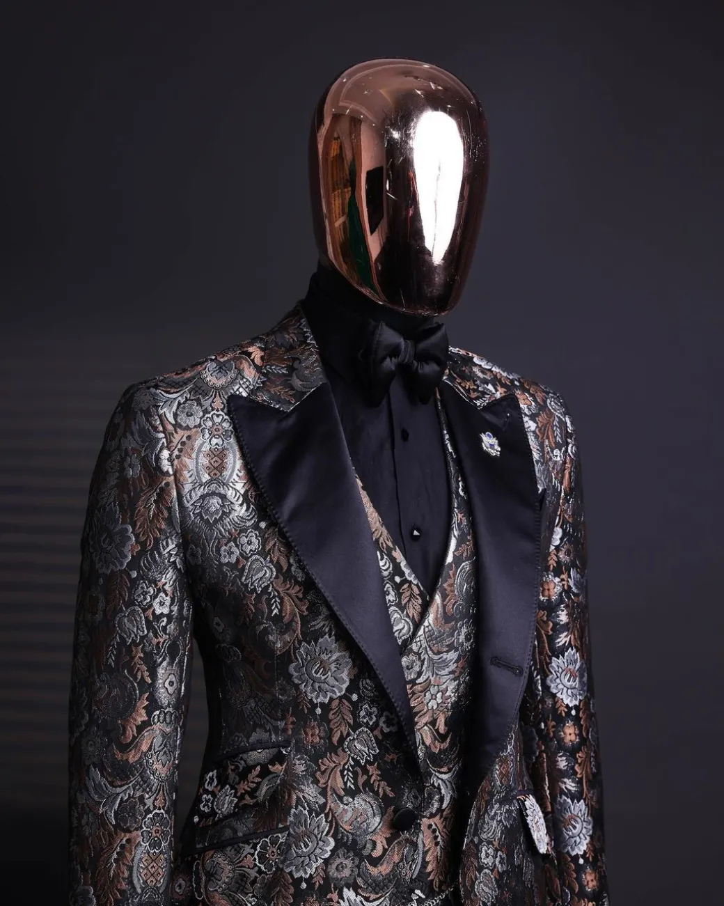 A knitted, brown, silver and black floral jacquard peak lapel suit