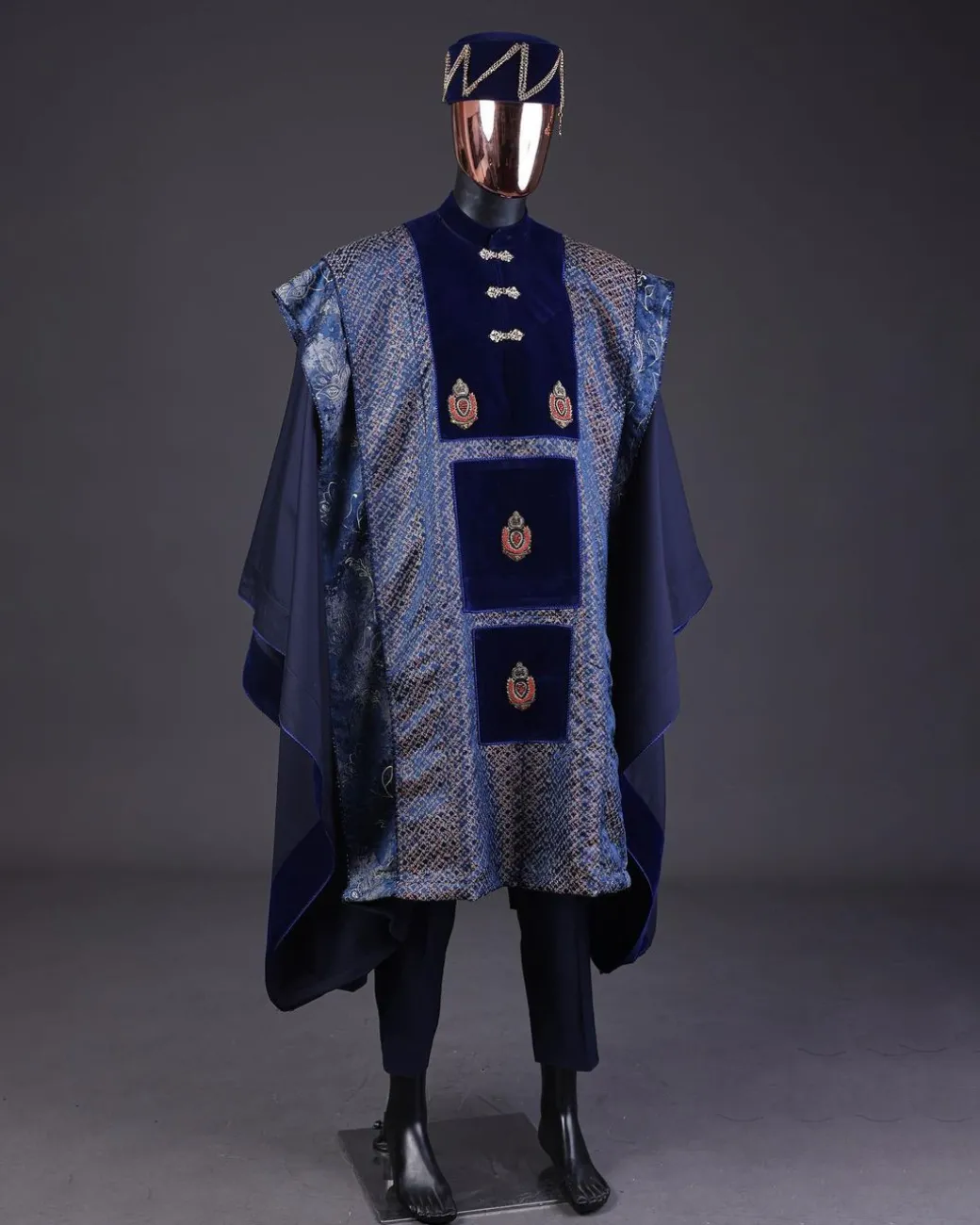 A “krosscut” layered, minted Gold, Skye, navy and admiral blue mix metallic jacquard front cut agbada.