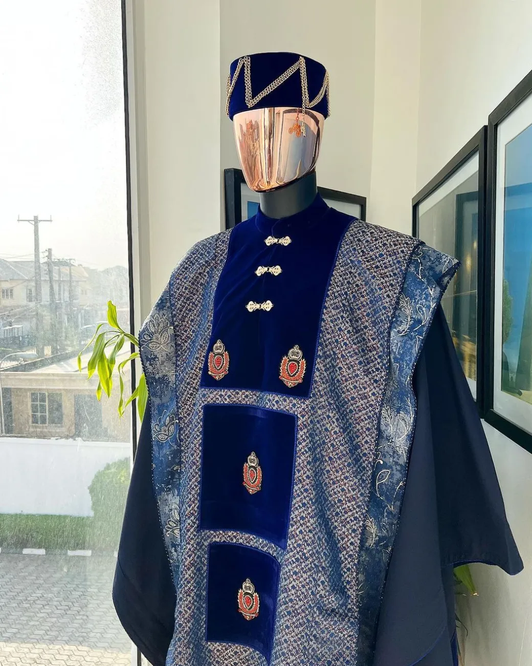 A “krosscut” layered, minted Gold, Skye, navy and admiral blue mix metallic jacquard front cut agbada.