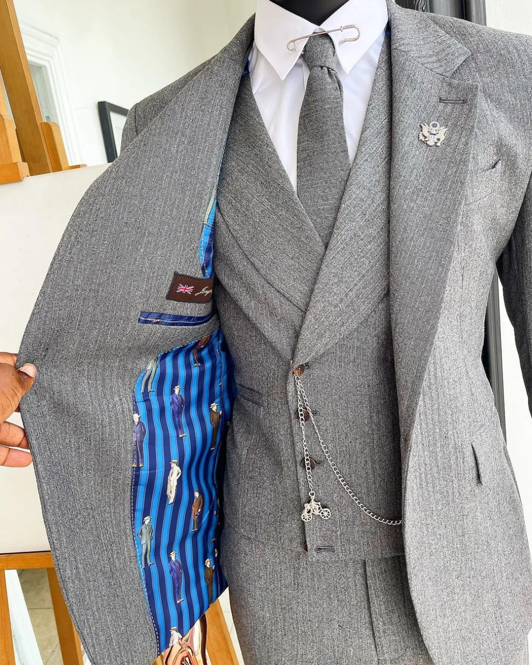 A Lava Grey, herringbone-patterned fabric Jorgecarli Super 140’s “Board Room” notch lapel suit