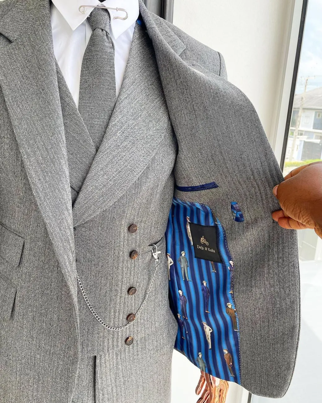 A Lava Grey, herringbone-patterned fabric Jorgecarli Super 140’s “Board Room” notch lapel suit