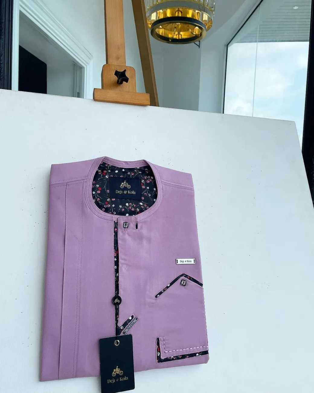 A lavender-purple invisible flap with an invisible pocket, paisley, and Swarovski button details African traditional senator Kaftan native