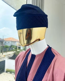 A light beige agbada with a navy blue uncoordinated lines embroidery design, Yoruba embroidery hat, kaftan and sokoto