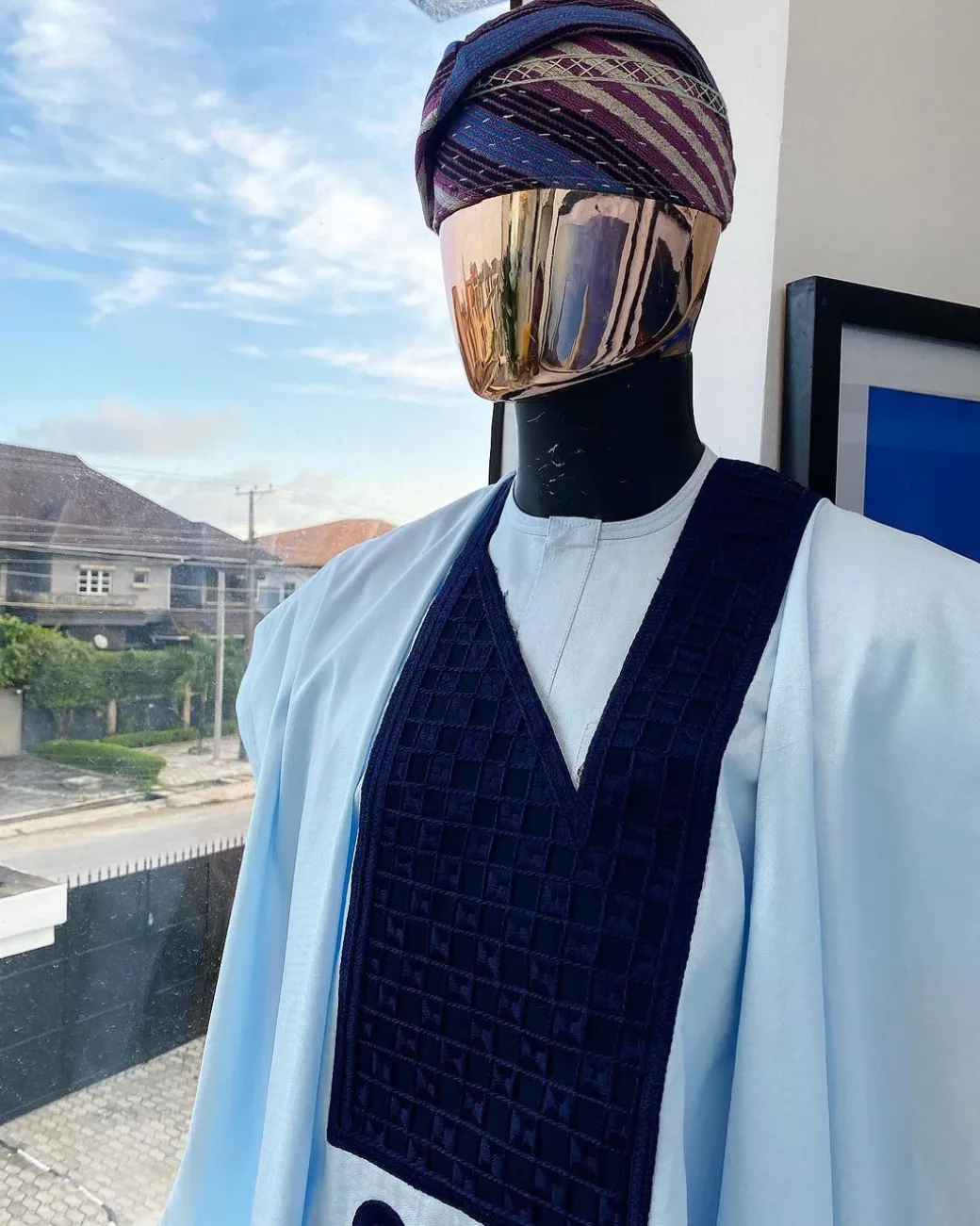 A Light blue, connected square navy blue embroidery Agbada