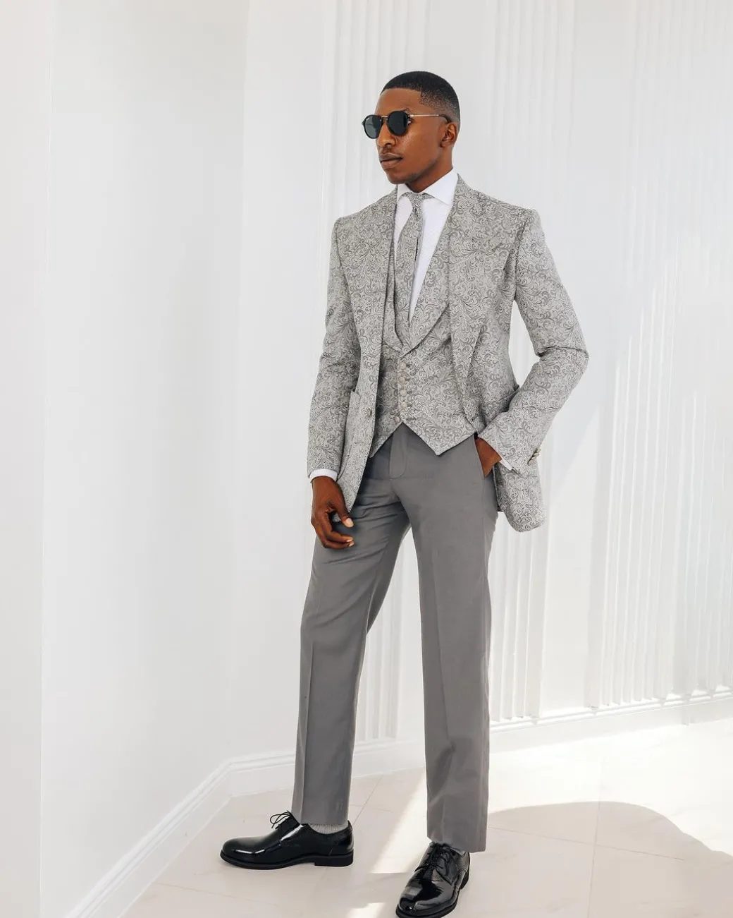 A Light grey & black floral jacquard peak lapel suit.