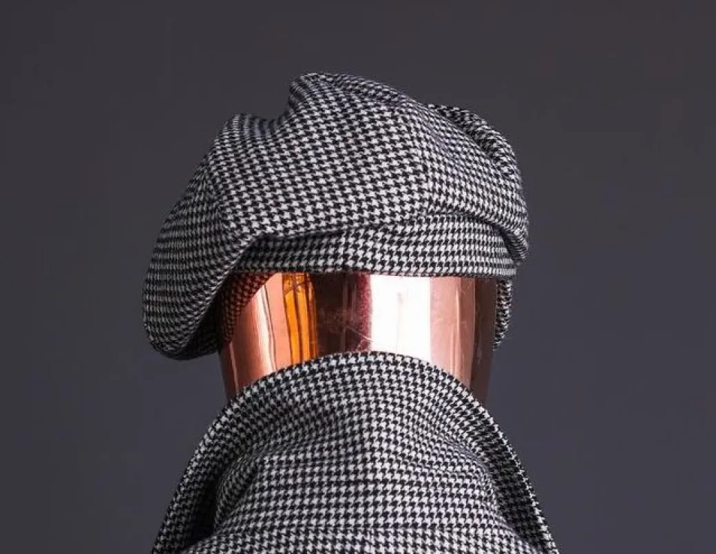 A Light Grey And Black Mix Of Houndstooth Check Hat.