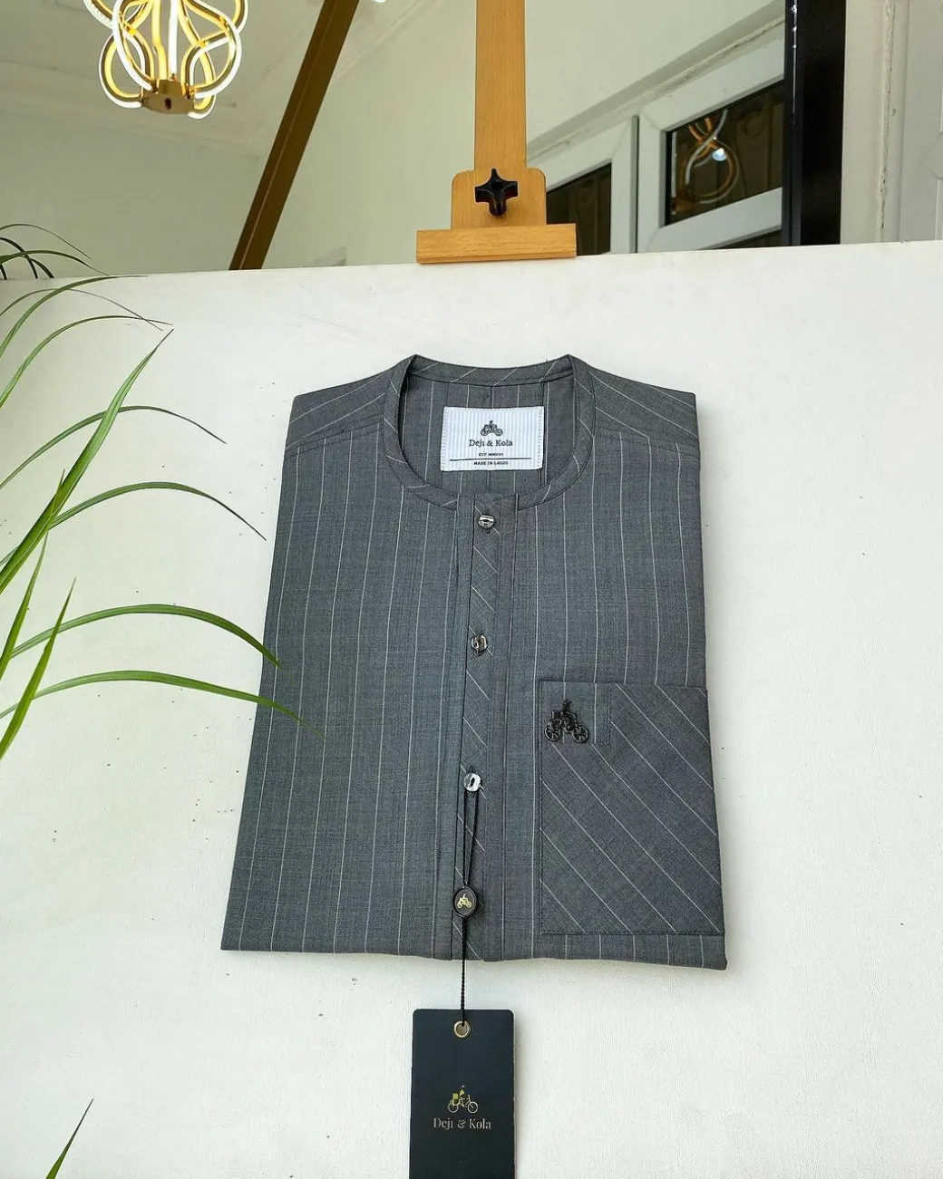 A light grey stripe front flap, Swarovski stone button with a maze line design African kaftan