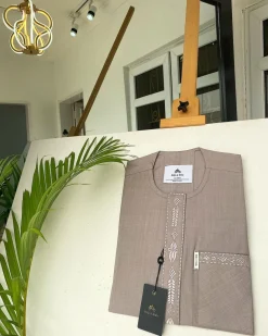A light lilac senator African kaftan with a dispersed connected embroidery design