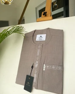 A light lilac senator African kaftan with a dispersed connected embroidery design