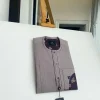 A liver brown, curved reverse pocket, front flap with purple Swarovski African kaftan native
