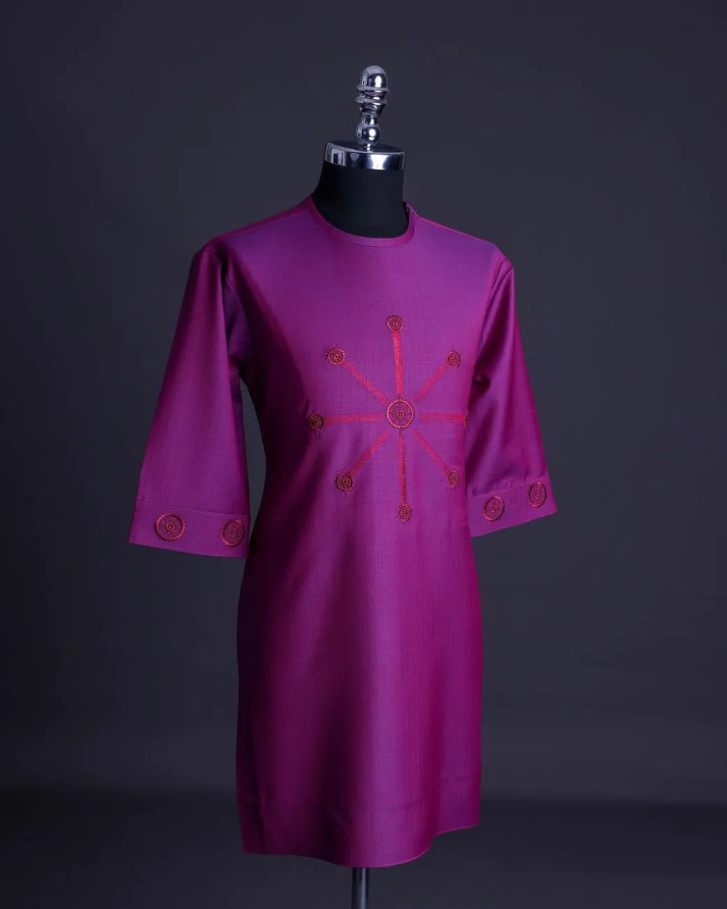 A Magenta, herringbone fabric, and interconnected ring embroidery details African senator kaftan native