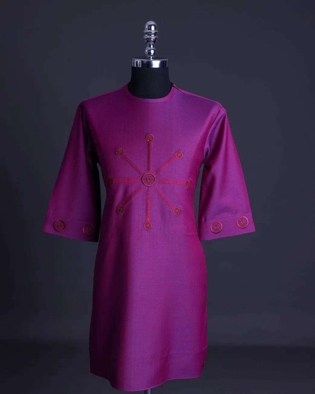 A Magenta, herringbone fabric, and interconnected ring embroidery details African senator kaftan native
