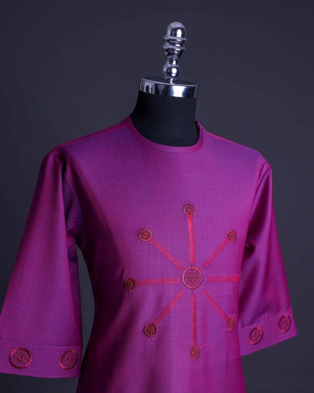 A Magenta, herringbone fabric, and interconnected ring embroidery details African senator kaftan native