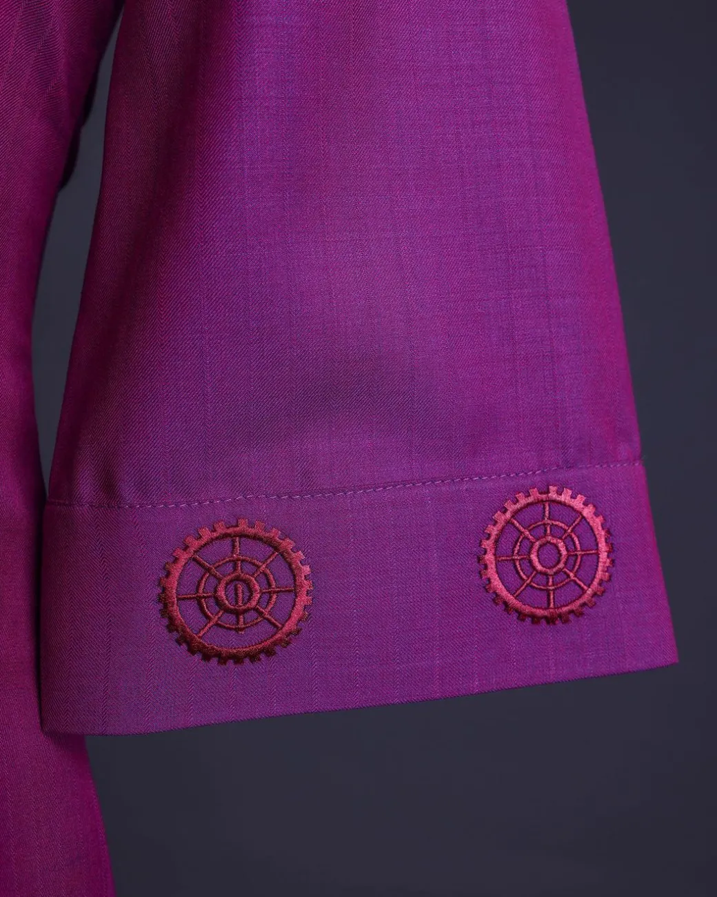 A Magenta, herringbone fabric, and interconnected ring embroidery details African senator kaftan native