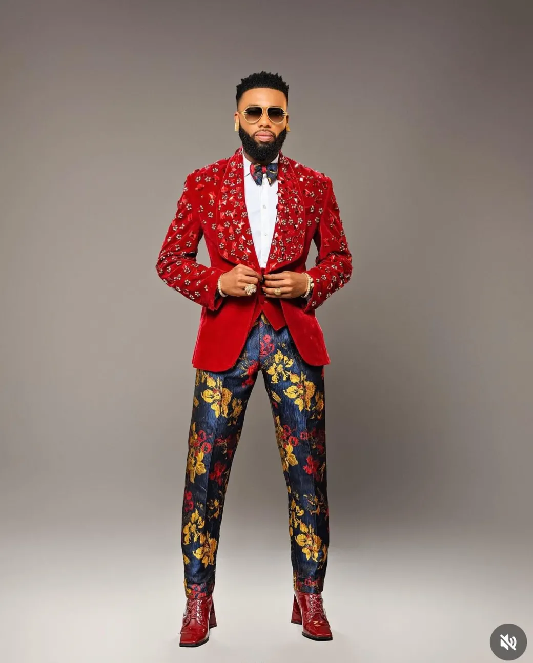 A Mahogany red shawl lapel tuxedo with black and octagonal laser-cut matching Swarovski stones suit