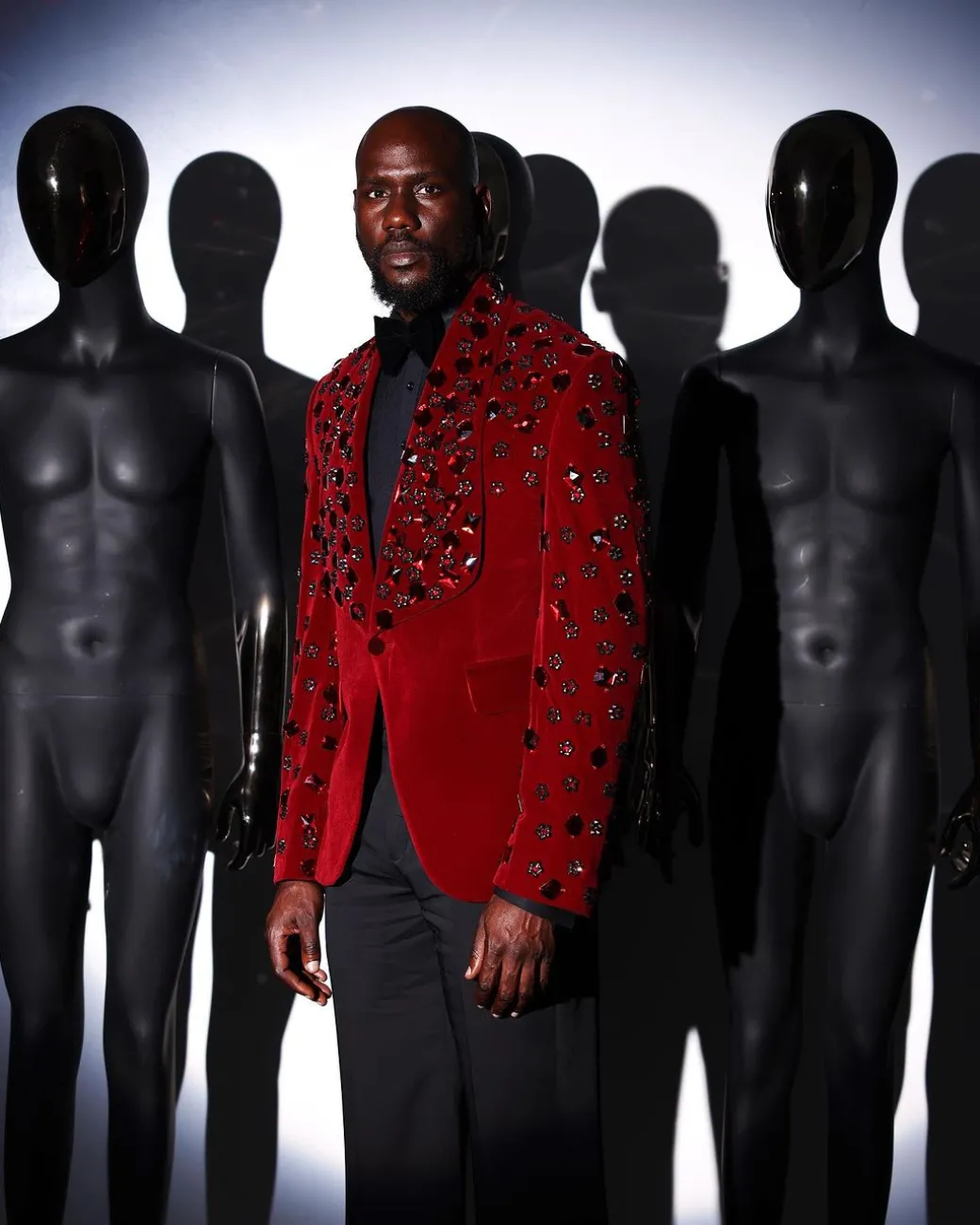 A Mahogany red shawl lapel tuxedo with black and octagonal laser-cut matching Swarovski stones suit