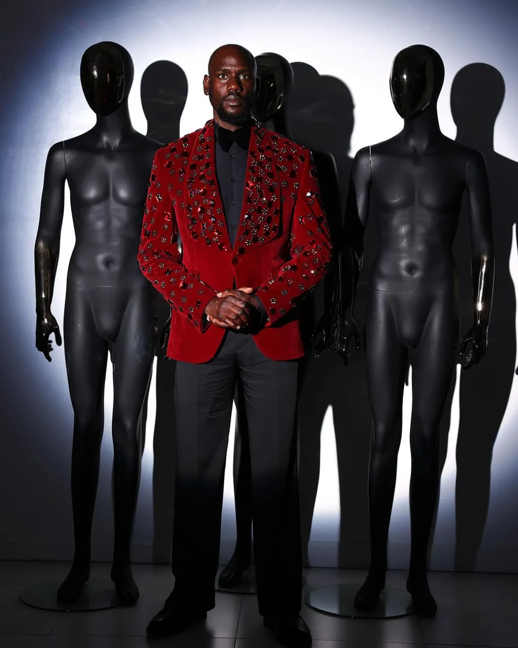A Mahogany red shawl lapel tuxedo with black and octagonal laser-cut matching Swarovski stones suit