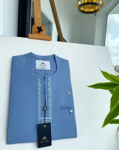 A Maya blue rail line flap with a combat pocket Swarovski button details African traditional senator Kaftan.