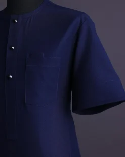 A Midnight blue, broken square pattern, Jorgecarli, front flap with black Swarovski button, 3/4 sleeve African senator Kaftan native.