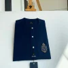 A midnight blue, front flap, hand embroidery patch detailing, and Swarovski button African Kaftan