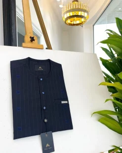 A midnight blue, light blue pencil stripe, clear view Swarovski buttons, horizontal line square embroidery details African traditional senator kaftan native.