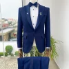 A midnight blue peak lapel floral jacquard tuxedo suit