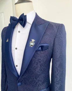 A midnight blue peak lapel floral jacquard tuxedo suit