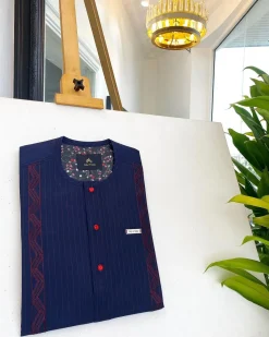 A midnight blue, red pencil stripe, clear view lipstick, red buttons, and horizontal embroidery details African traditional senator Kaftan native