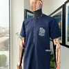 A Midnight blue, Skye blue, and black cloud pattern metallic Jacquard flap and pocket detailing African traditional senator kaftan native