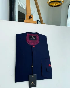A Midnight blue with paisley detailing, front flap, and a layered patch pocket with a matching Swarovski button African traditional kaftan native