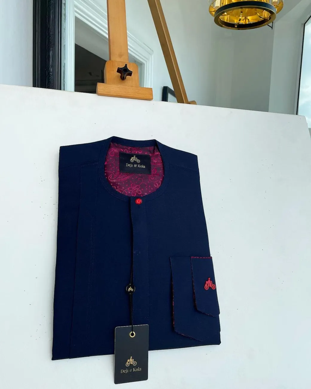 A Midnight blue with paisley detailing, front flap, and a layered patch pocket with a matching Swarovski button African traditional kaftan native