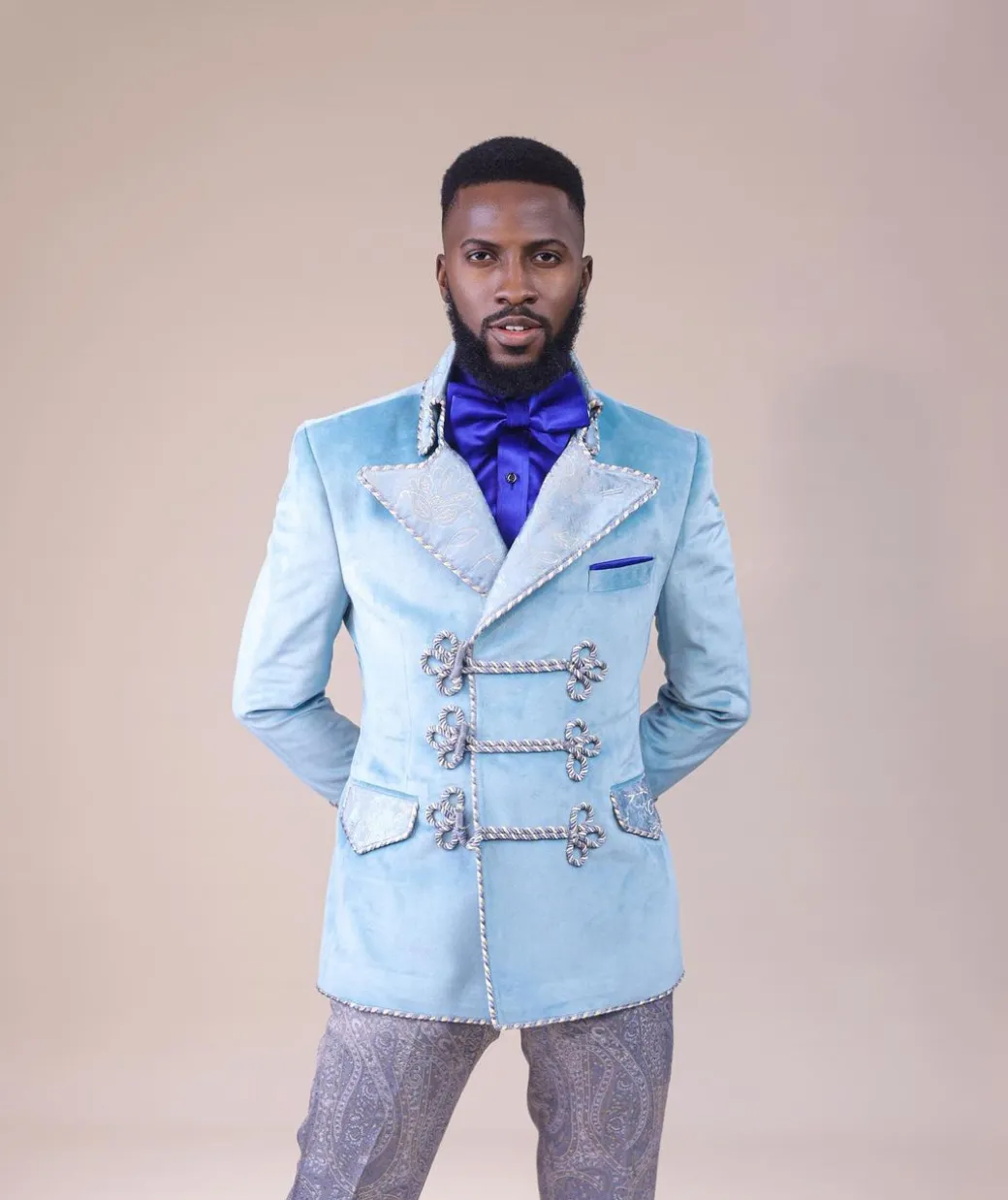 A “Milano” Skye blue, double breasted with matching gold floral detailing, hand knitted buttons