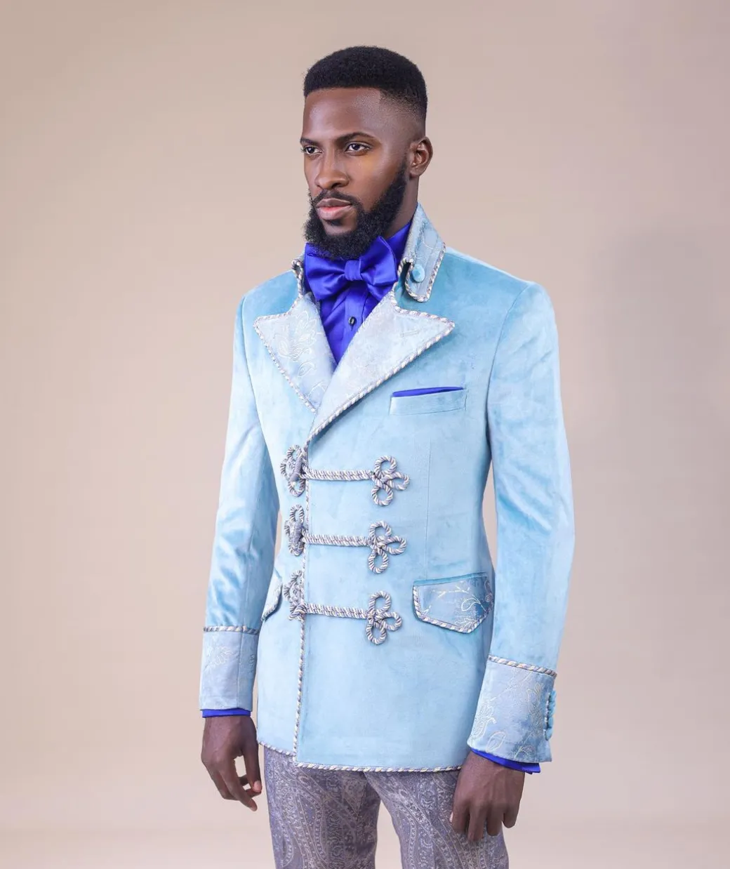 A “Milano” Skye blue, double breasted with matching gold floral detailing, hand knitted buttons