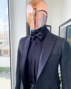 A monochrome charcoal black, peak lapel, metallic Jacquard tuxedo suit.