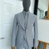 A monochrome seersucker (rail road stripe) notch lapel suit