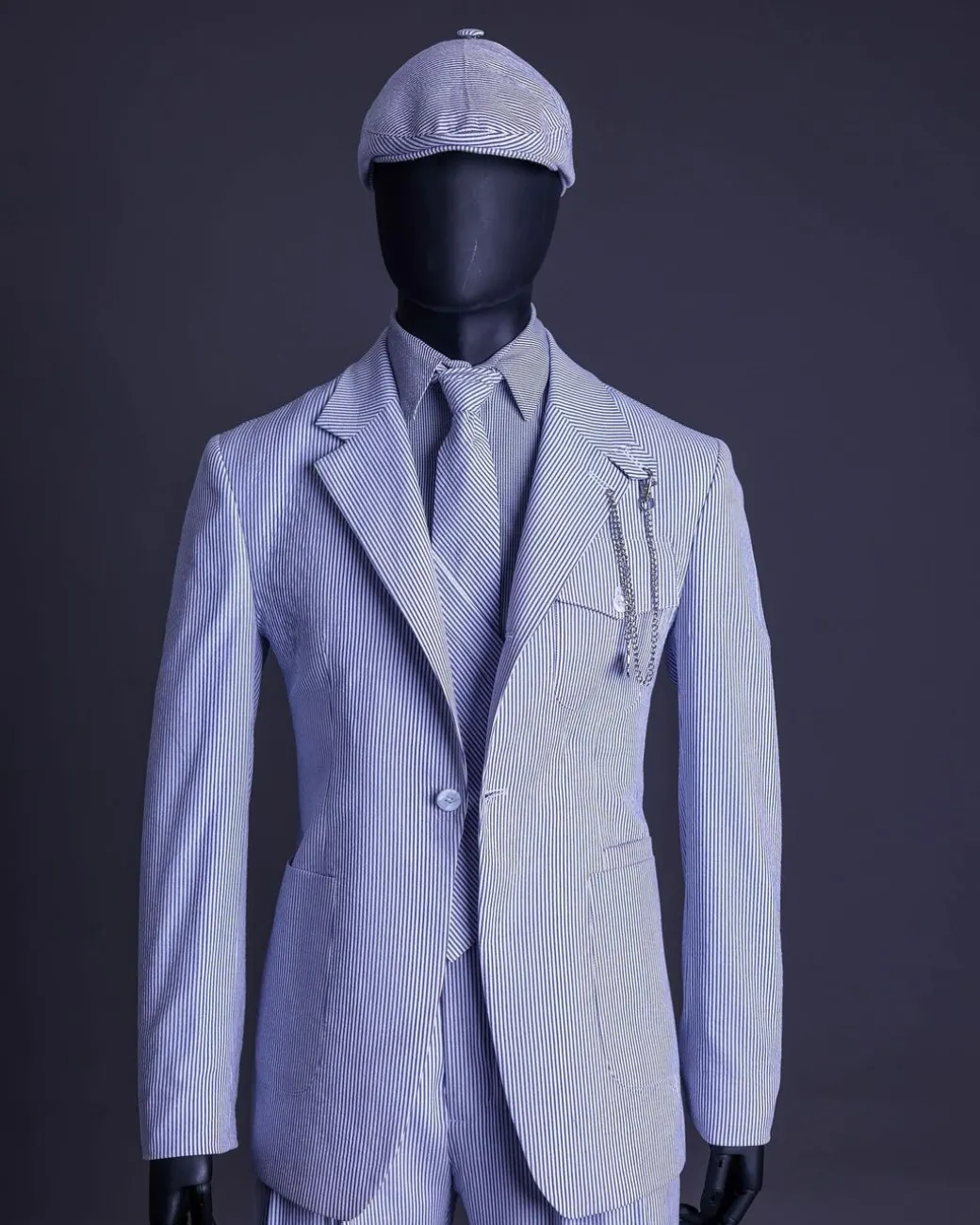 A monochrome seersucker (rail road stripe) notch lapel suit