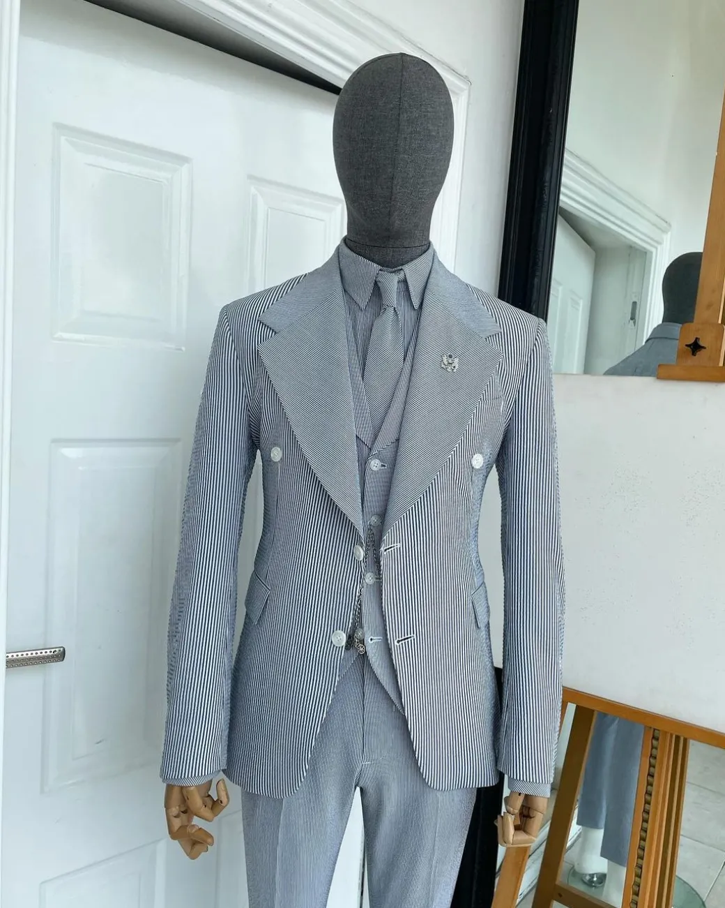 A monochrome seersucker (rail road stripe) notch lapel suit