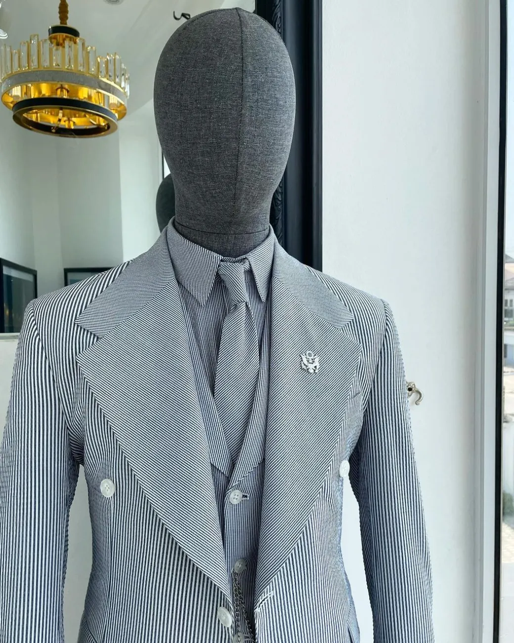 A monochrome seersucker (rail road stripe) notch lapel suit